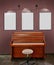 Old upright piano and a stool and three blank frames against Glitter wall