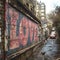 Old urban brick wall with pink graffiti street art word Love lettering.