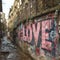 Old urban brick wall with pink graffiti street art word Love lettering.