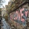 Old urban brick wall with pink graffiti street art word Love lettering.