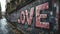 Old urban brick wall with pink graffiti street art word Love lettering.