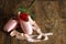 Old used ballet slippers lying on floor with rose and petal