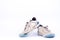 Old used blue worn out futsal sports shoes on white background football isolated