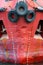 Old used car tires as fender on a shipboard. Red ship hull with