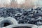 Old used damaged car tires at the dump