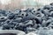 Old used damaged car tires at the dump