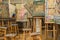 Old used easels in art studio. Artist`s palette with oil paints