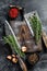 Old Used Meat Cleaver and knife with wooden cutting board. Black background. Top view