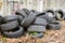 Old used rubbish tires lies near the wall