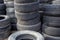 Old used small car tires stacks full frame background