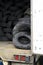 Old used tires are stored inside an old semi trailer with an ope