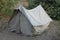 A old USSR tent on a picnic in a forest on a sand with grass