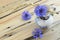 Old vase with cornflowers and ears of wheat