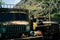 Old vehicles on rural road in mountains. Shabby trucks parked on old asphalt road in highland area on sunny day