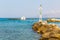 Old venetian lighthouse at harbor in Crete, Greece. Small cretan village Kavros.