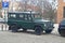 Old veteran or youngtimer private dark green big offroad 4wd car Landrover Defender parked