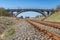 Old viaduct over the railway tracks. Concrete bridge over the railroad