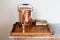 Old victorian copper tea urn and tea caddy on a wooden tray