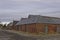 An old Victorian ruined Barn and Agricultural Store Complex under dark winter skies.