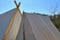 Old vikings tent made of cloth and wood in front of a blue sky