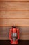 Old vinatge red kerosene oil lamp on wooden wall background