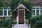 Old vine covered house with leaded glass windows