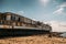 Old vintage abandoned rusted ship run aground after shipwreck accident in beginning of XX century in Crimean coast on sand beach