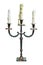 Old vintage ancient baroque metal candlestick with three white melted candles