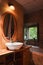 Old vintage bathroom with modern basin and bath tub with open window and tree, in the nature