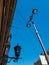 Old vintage black dark glass street lamp hanging on textured wall of beautiful building and lantern post, pillar in city of Saint
