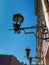 Old vintage black glass street lamps hanging on wall of beautiful building in of Saint Petersburg in the light of sun. City street