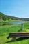 Old vintage boat on the coast of river and green forest