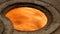 Old vintage brick oven with cast-iron pancakes, in which fire burns close up view