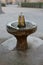 Old Vintage bronze drinking fountain on a stone basement