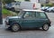 Old vintage classic dark green Morris Mini Cooper parked