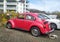 Old vintage classic red car Volkswagen Beetle left side and rear compartment view