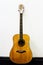 Old vintage classic wooden acoustic guitar near wall