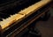 Old vintage classical black piano in dramatic light on dark back