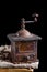 Old vintage coffee grinder with roasted coffee beans. Dark still life