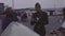 Old vintage color film young soldier eating with parents near car at parking lot