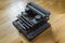 Old vintage dust-covered typewriter with sheet of white paper