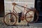 Old Vintage Fashioned Pink Bicycle supported by a wall