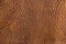 Old vintage genuine soft brown leather texture background, top layer with pores and scratches, macro, close-up