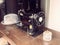 Old vintage German sewing machine on a wooden table with a hat.