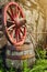 Old vintage hearse wheel and wooden barrel, rural scene