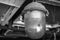 An old vintage lantern covered with dust and cobwebs under the garage roof, black and white shot