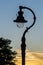 Old vintage lantern lamp post on the sunset sky background