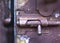 Old vintage latch lock on blue shabby cracked painted door