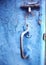 Old vintage latch lock on blue shabby cracked painted door