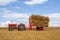 Old vintage Massey Ferguson and trailer in crop field